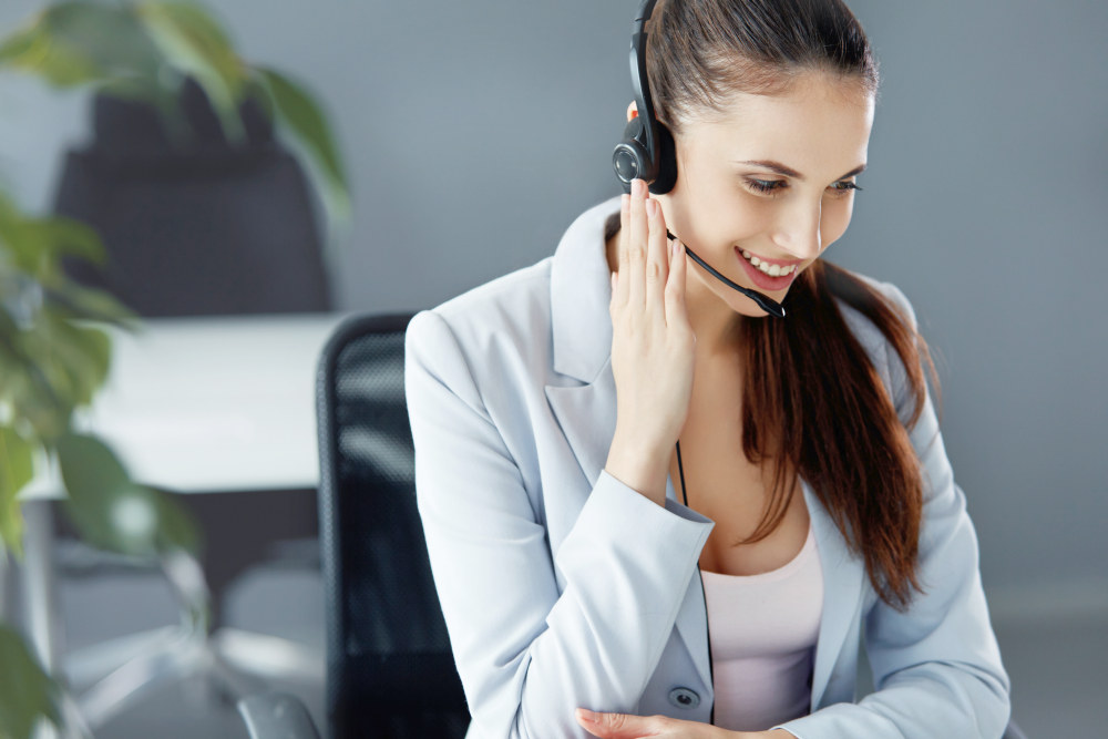 Call Center Operator Sitting Infront of Her Computer | Proven Tips To Making A Sales Voicemail Script | sales call script